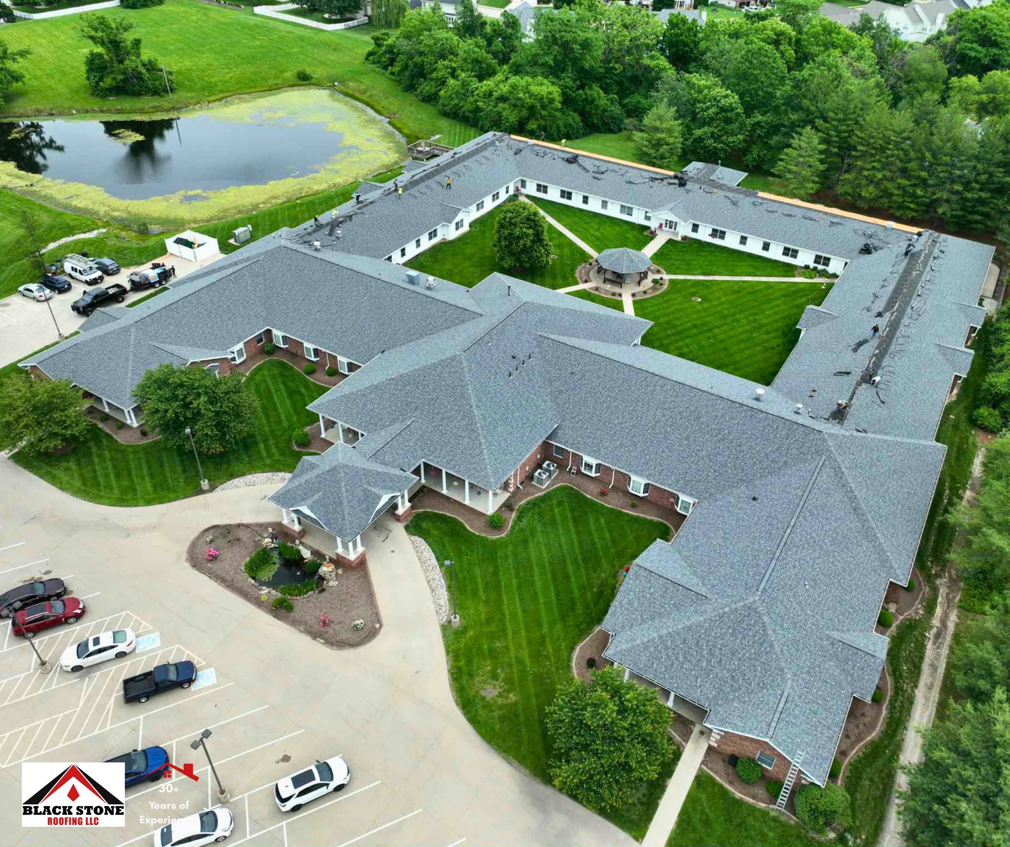 Black Stone Roofing crew replacing the shingle roof of a large senior living community