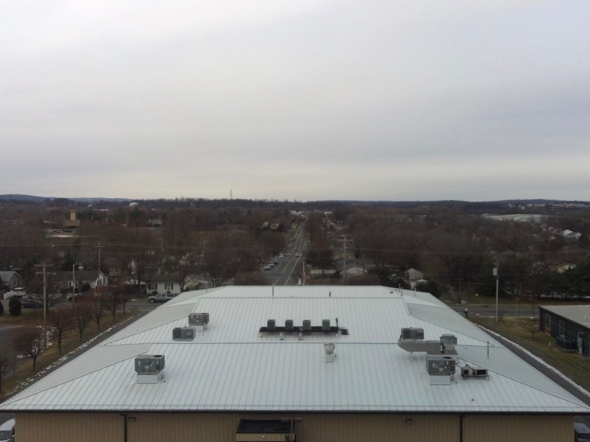 Aerial view of a white standing seam metal roof with rooftop HVAC units on a commercial building in Martinsburg WV
